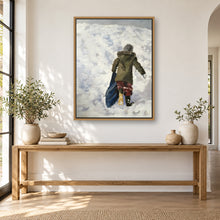 Load image into Gallery viewer, Child playing in the snow painting displayed in a framed neutral living room